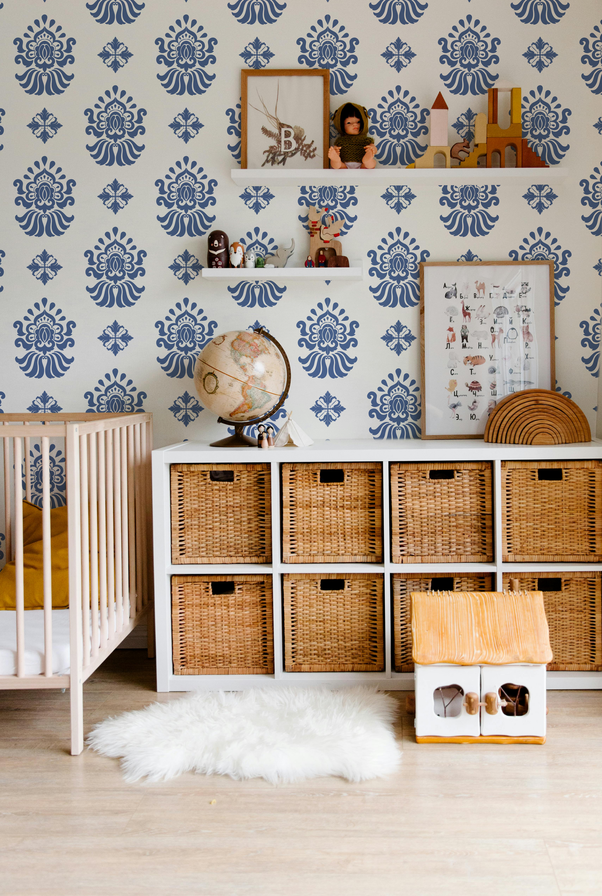 Navy blue and cream patterned wallpaper styled in a modern nursery and kids room