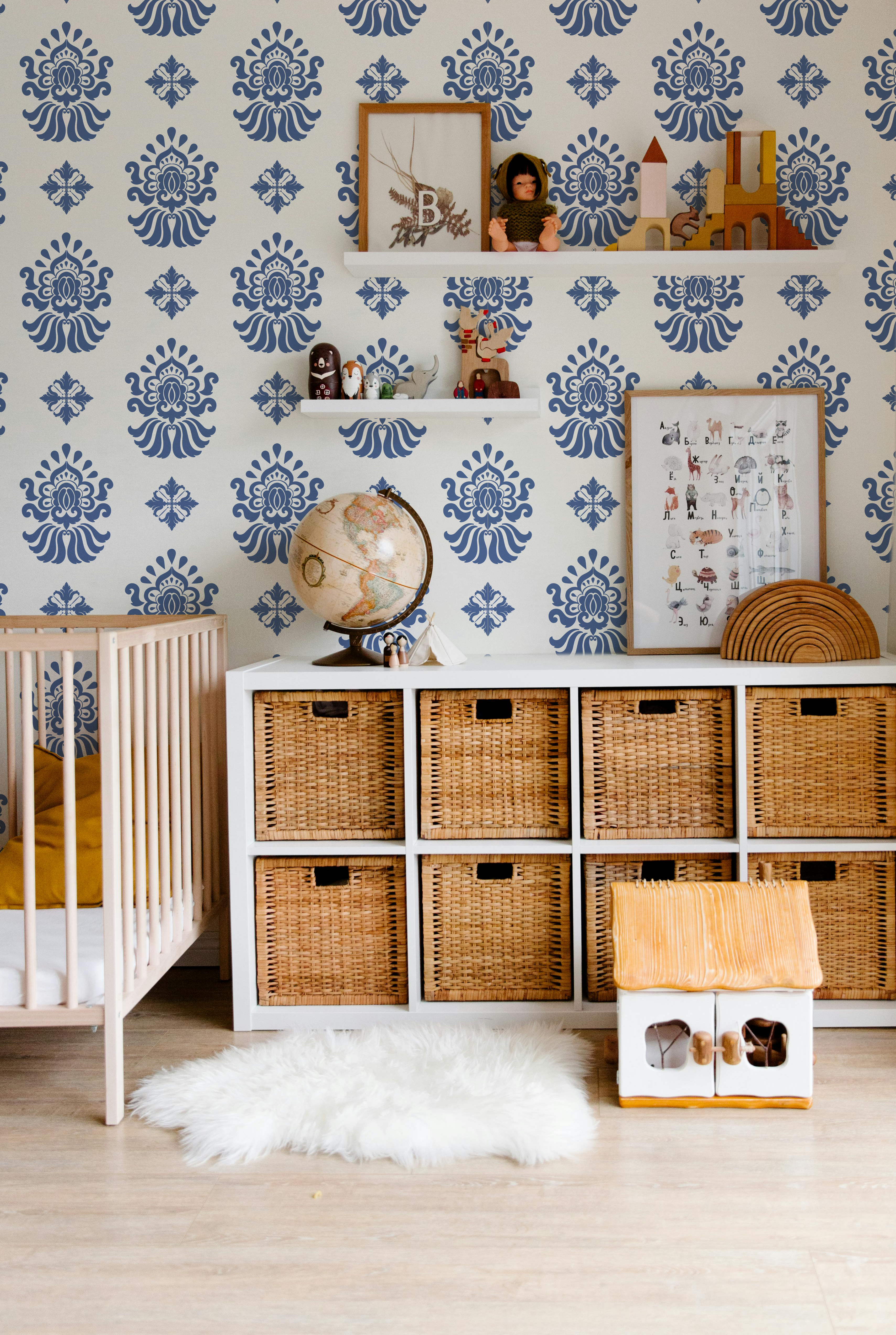 Navy blue and cream patterned wallpaper styled in a modern nursery and kids room