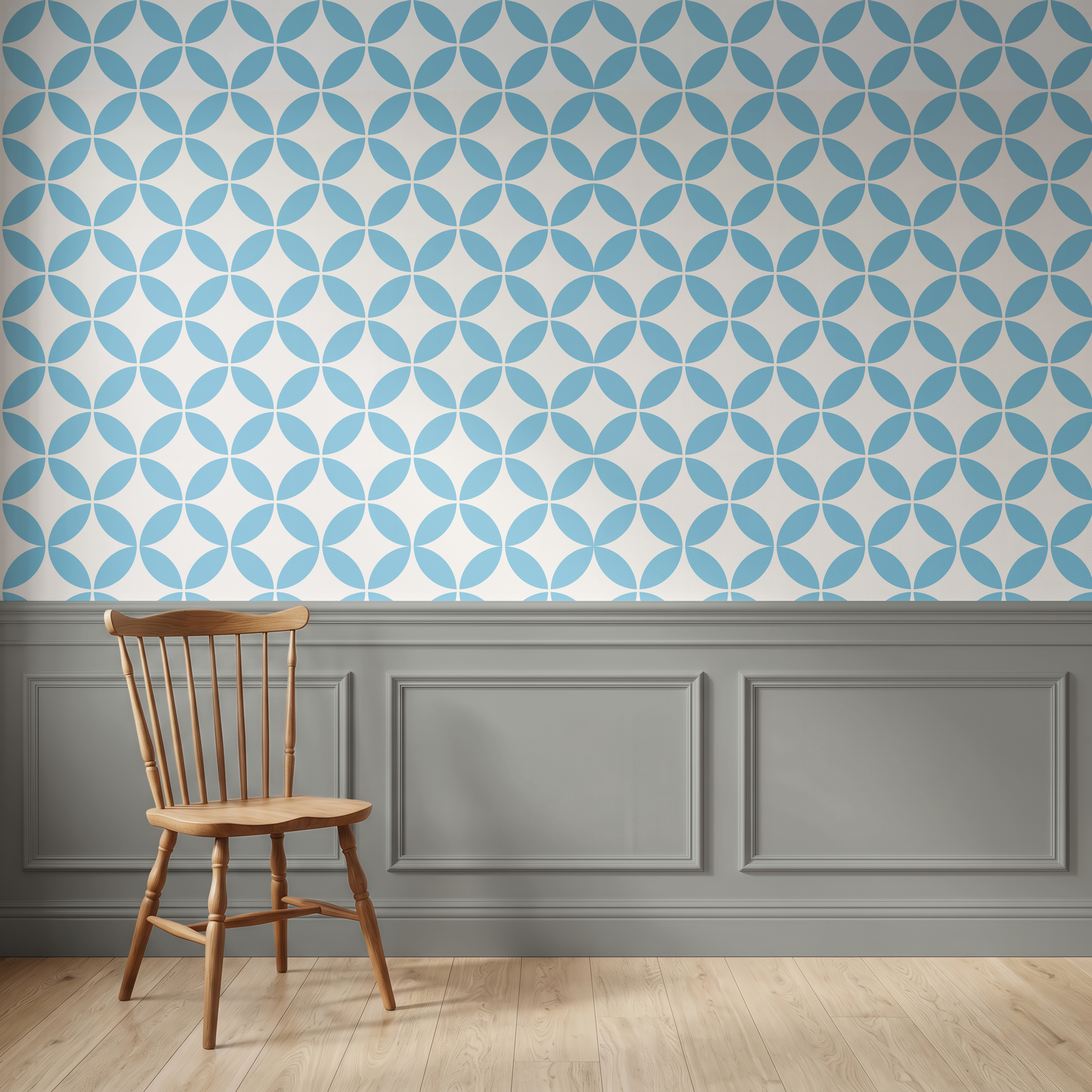 A room interior with a blue and white geometric wallpaper pattern on the upper wall, dark gray wainscoting along the lower wall, light wood flooring, and a wooden spindle-back chair in the foreground.