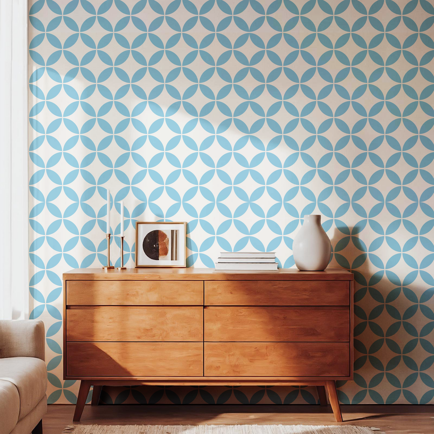 Light blue geometric pattern wallpaper styled with a warm wooden dresser