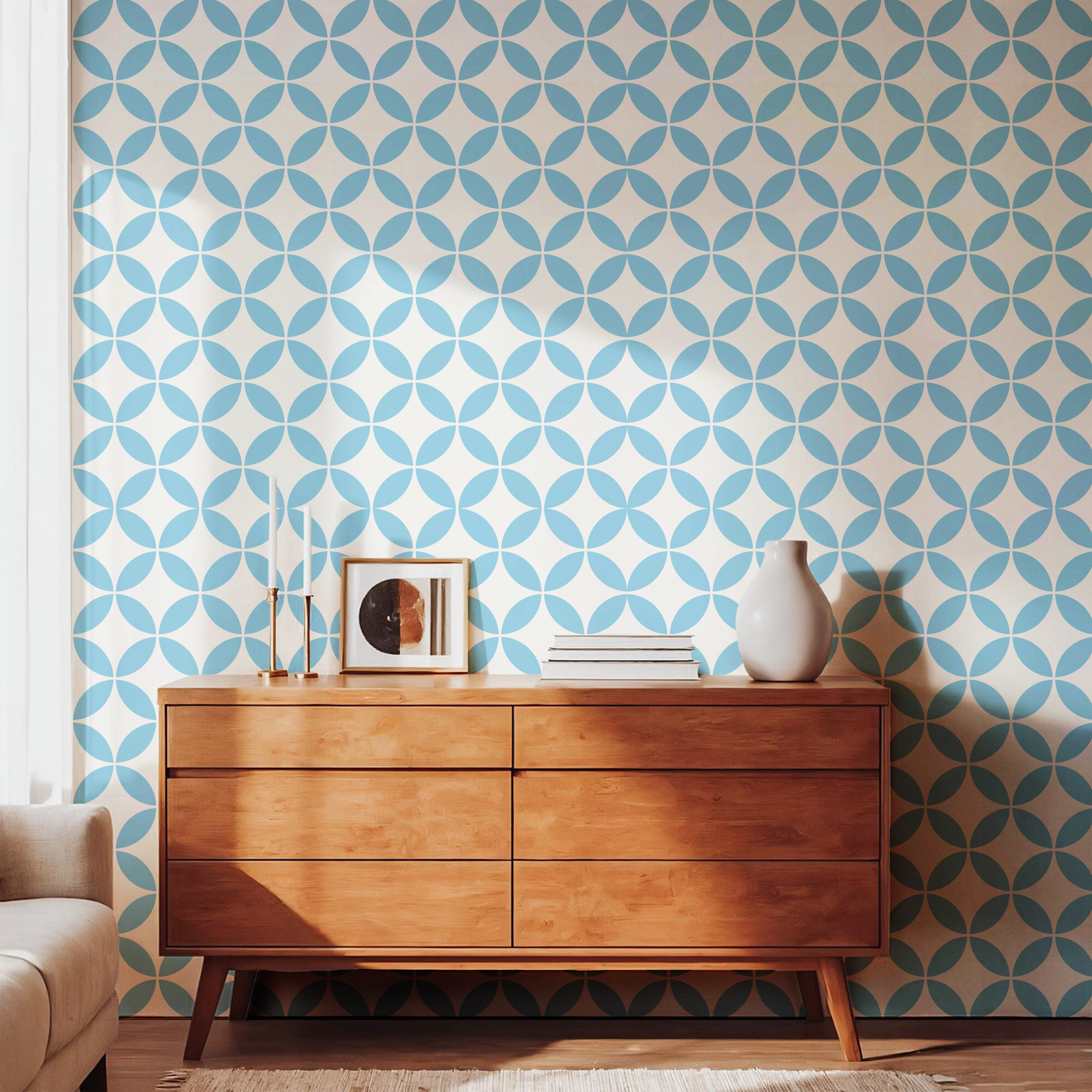 Light blue geometric pattern wallpaper styled with a warm wooden dresser