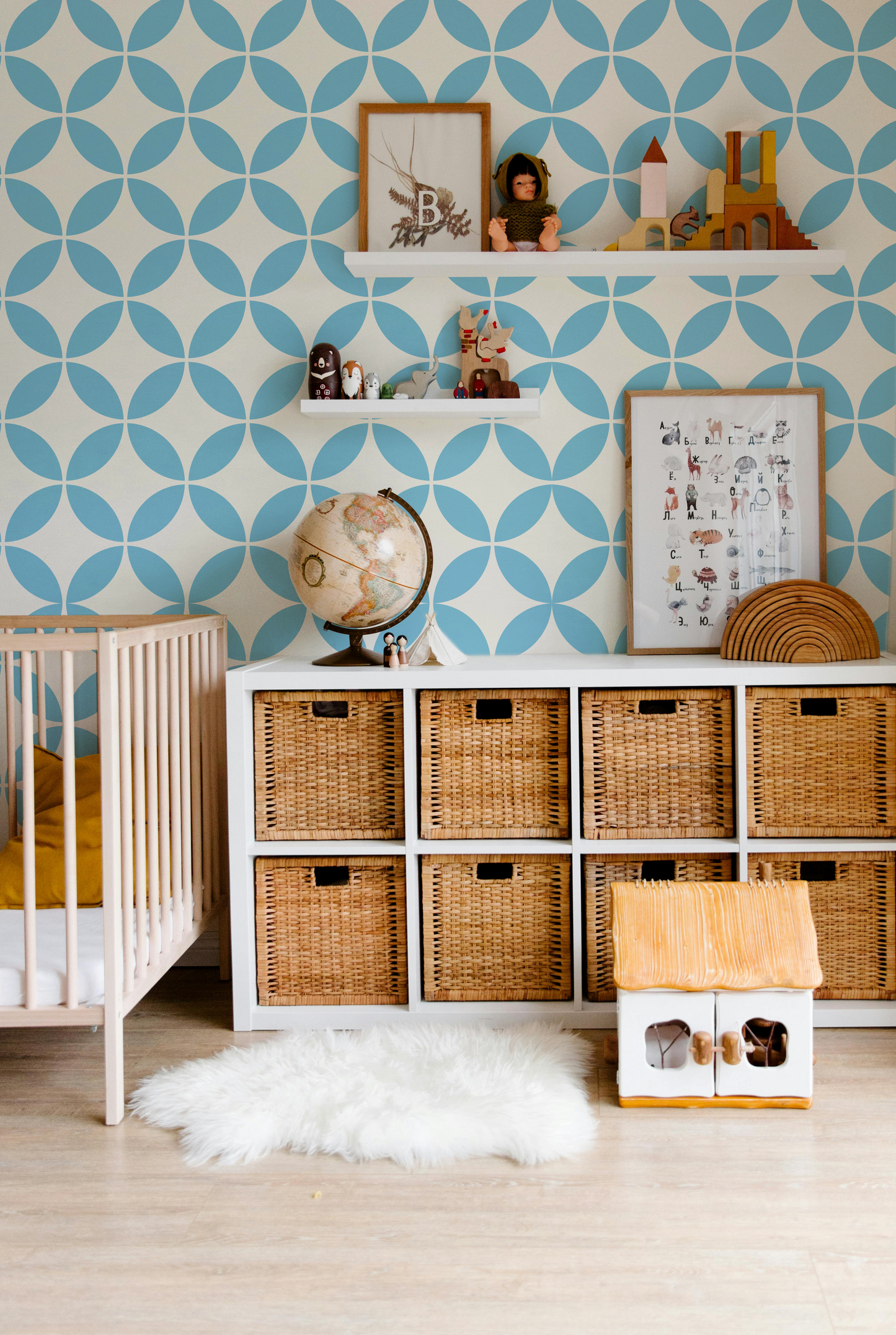 Light blue and cream geometric wallpaper styled in a modern nursery and kids room