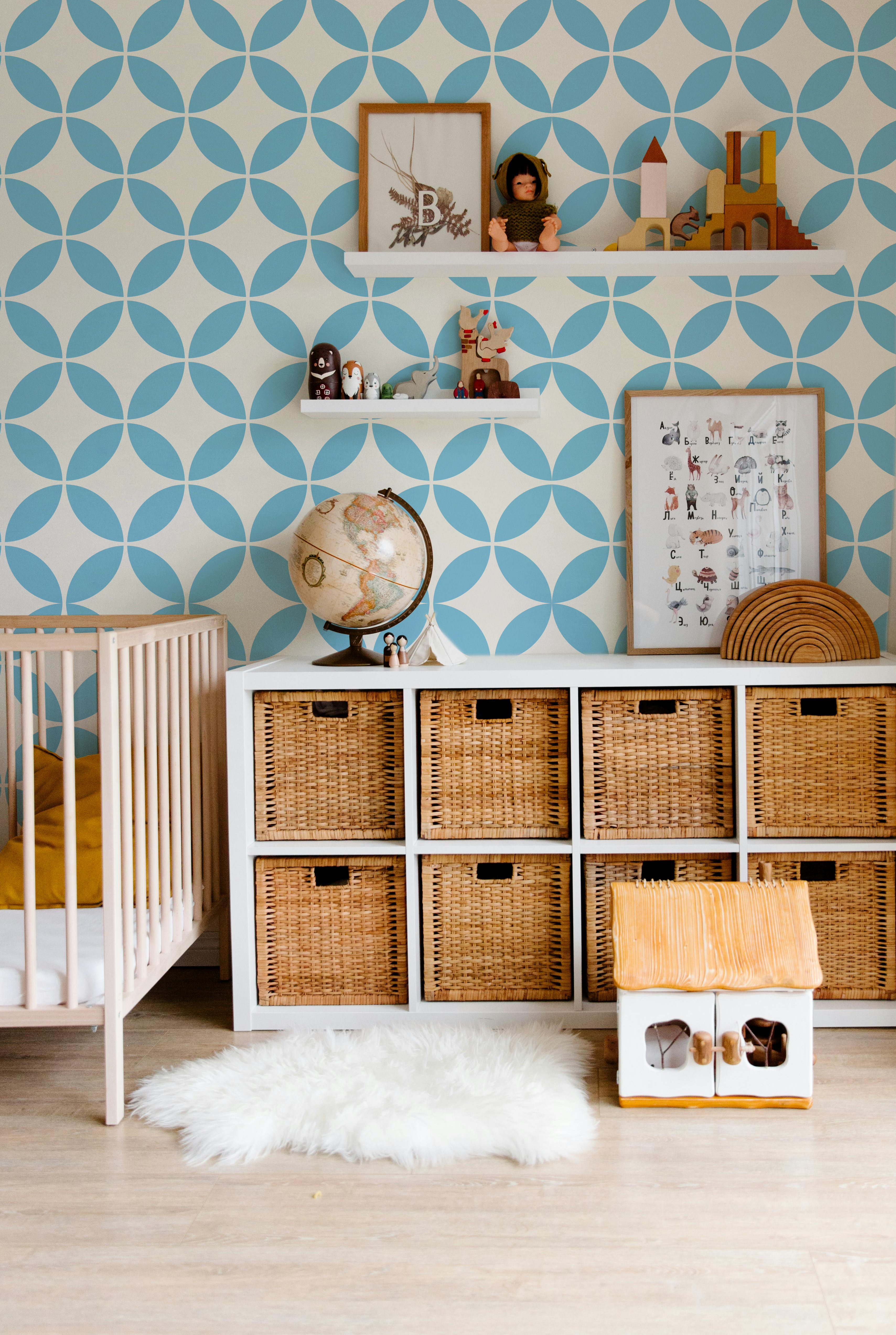Light blue and cream geometric wallpaper styled in a modern nursery and kids room