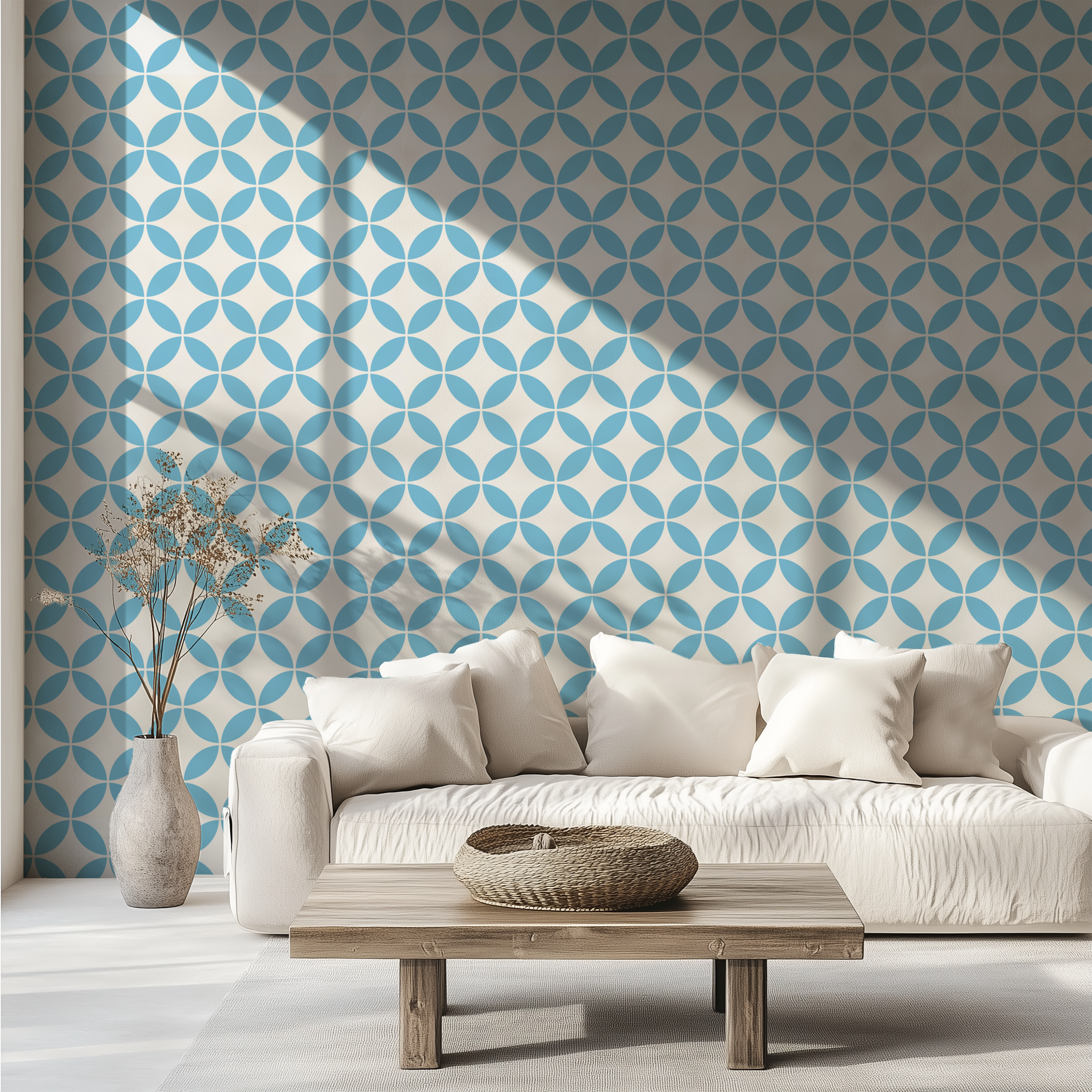 Light blue retro geometric wallpaper with interlocking circles behind a white sofa