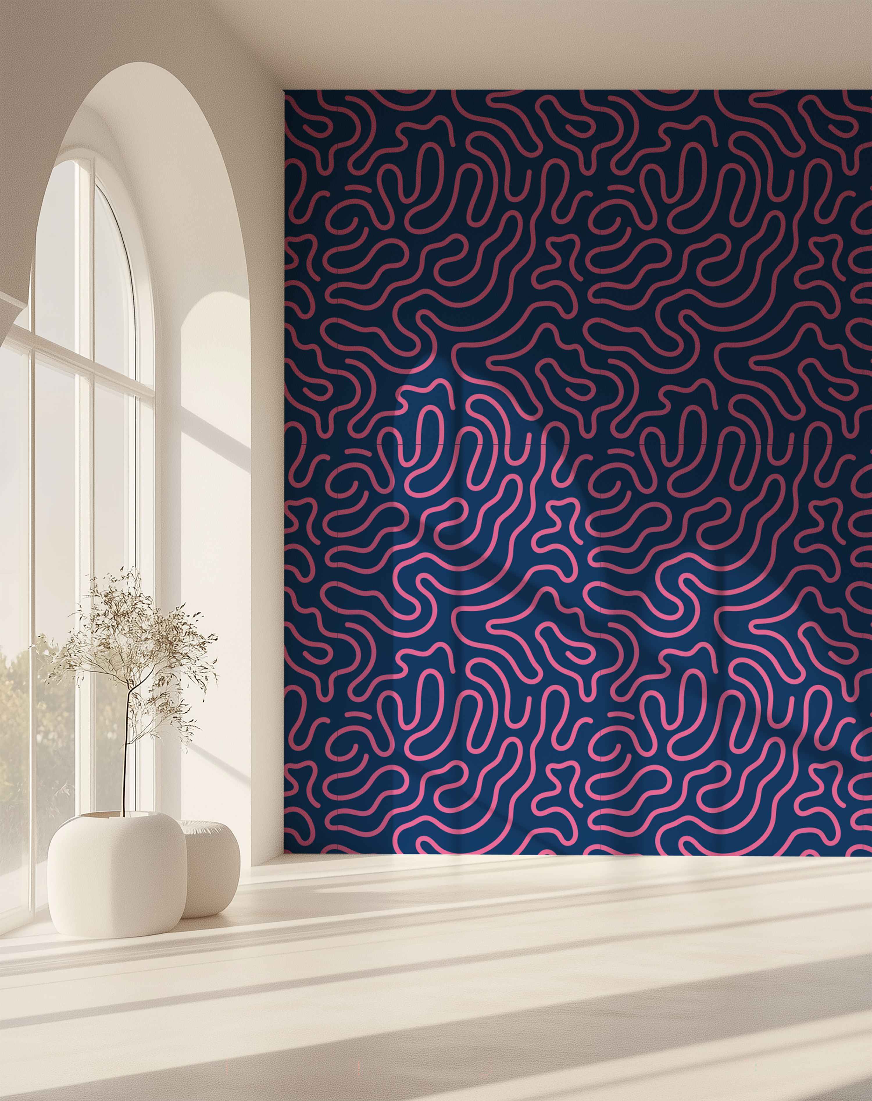 A large wallpaper mural featuring a dense abstract pattern of wavy magenta lines on a dark navy background, styled in a bright, modern room with a sunlit arched window and white ceramic vases.