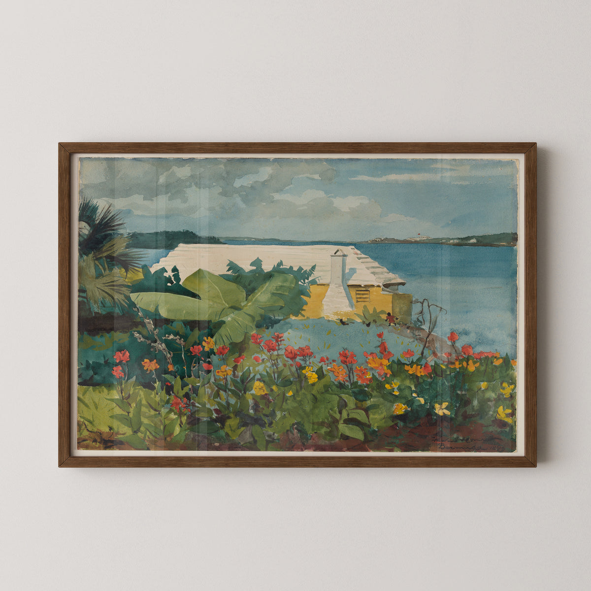 Dark wood-framed Bermuda garden print by Winslow Homer, with a yellow cottage and calm blue coastal water