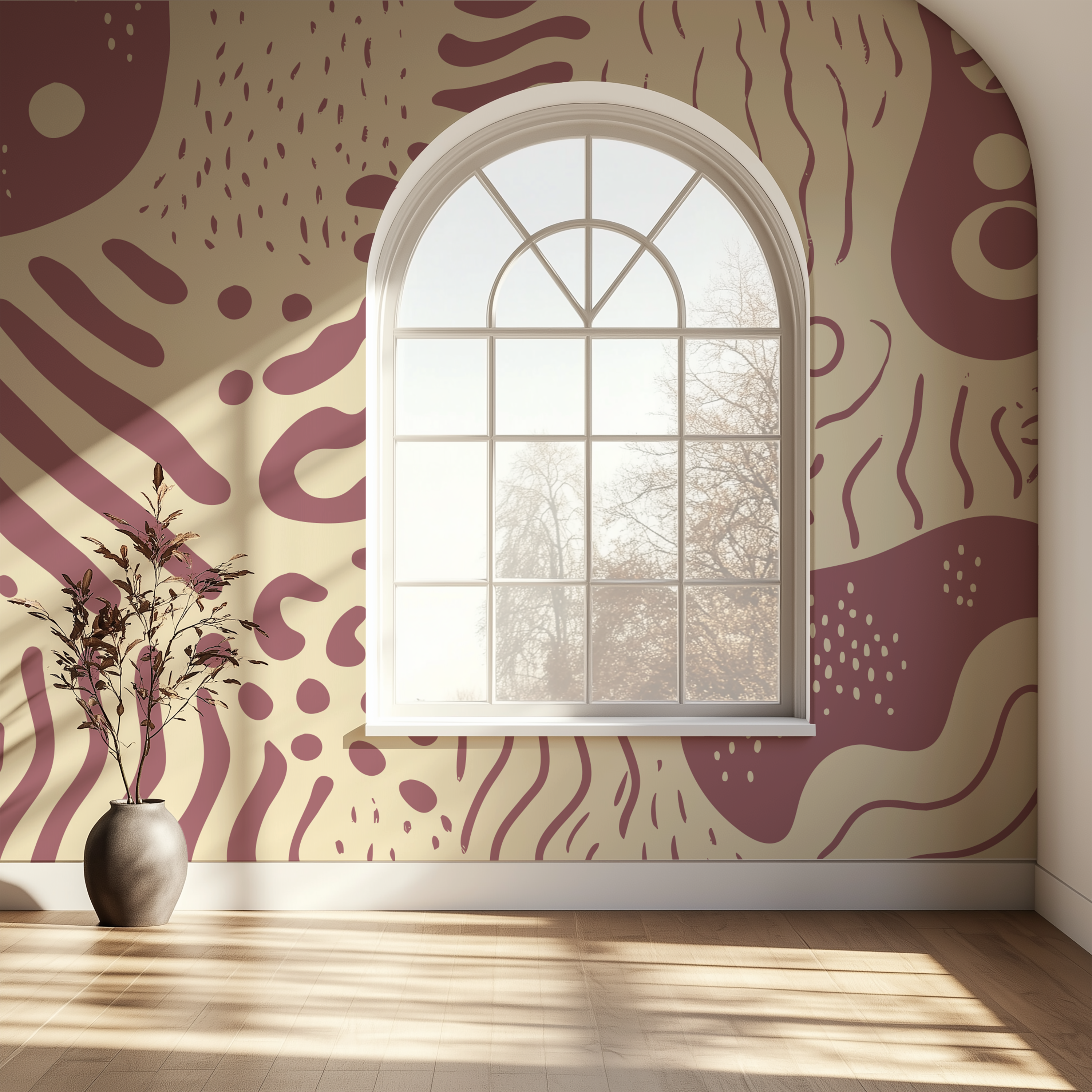 An arched window set in a wall with a bold abstract wallpaper pattern in dusty mauve and cream, with a vase of dried branches on a light wood floor in the foreground.