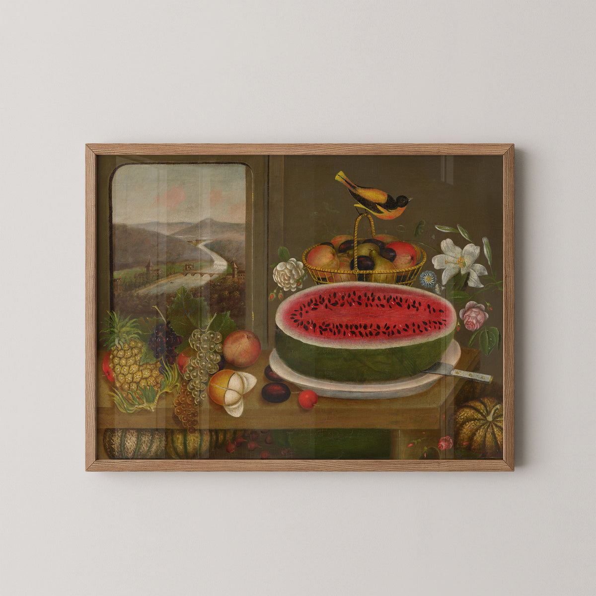Natural wood-framed Wagguno print with sliced watermelon, pineapple and grapes arranged on a table