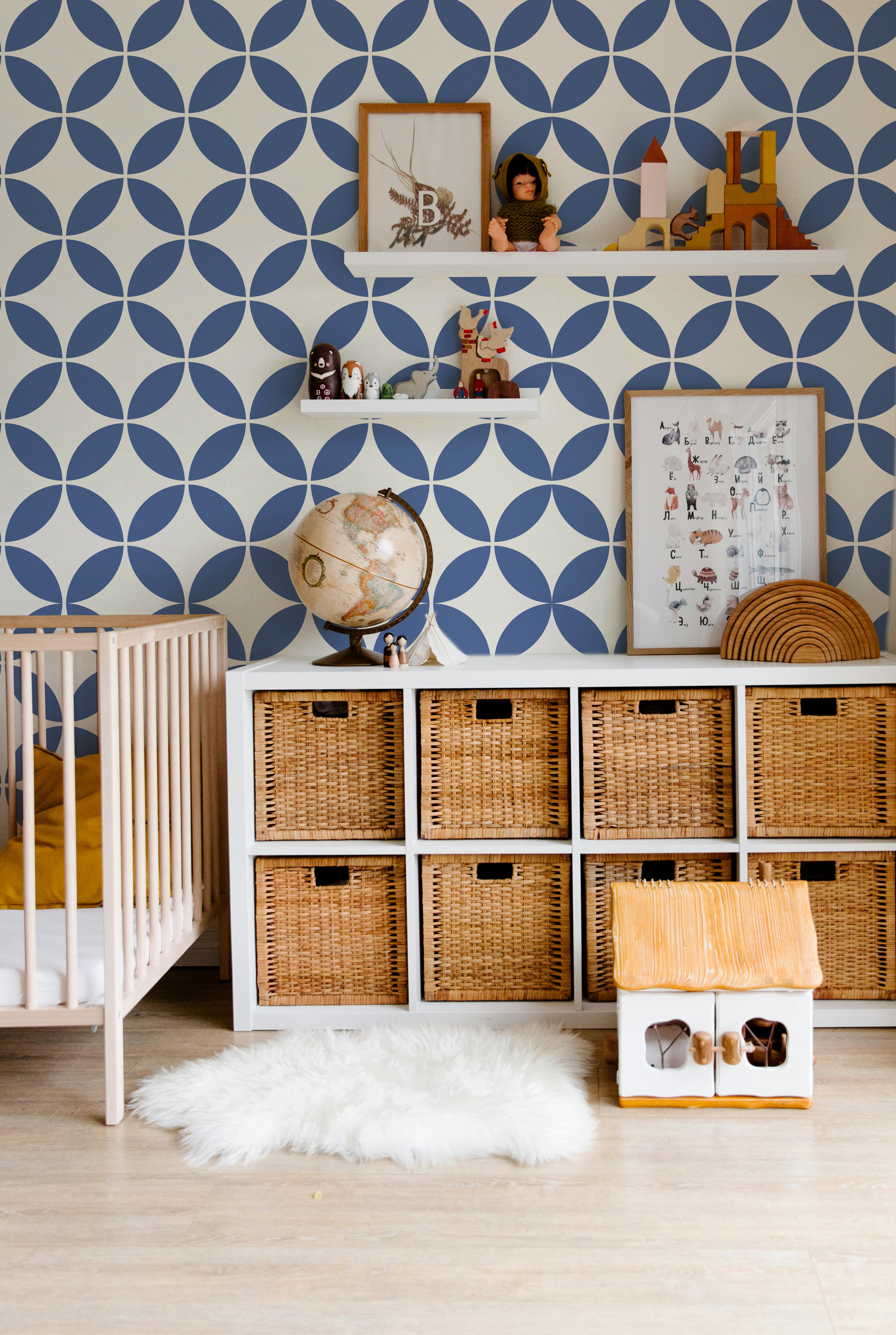 Navy blue and cream geometric wallpaper styled in a modern nursery and kids room