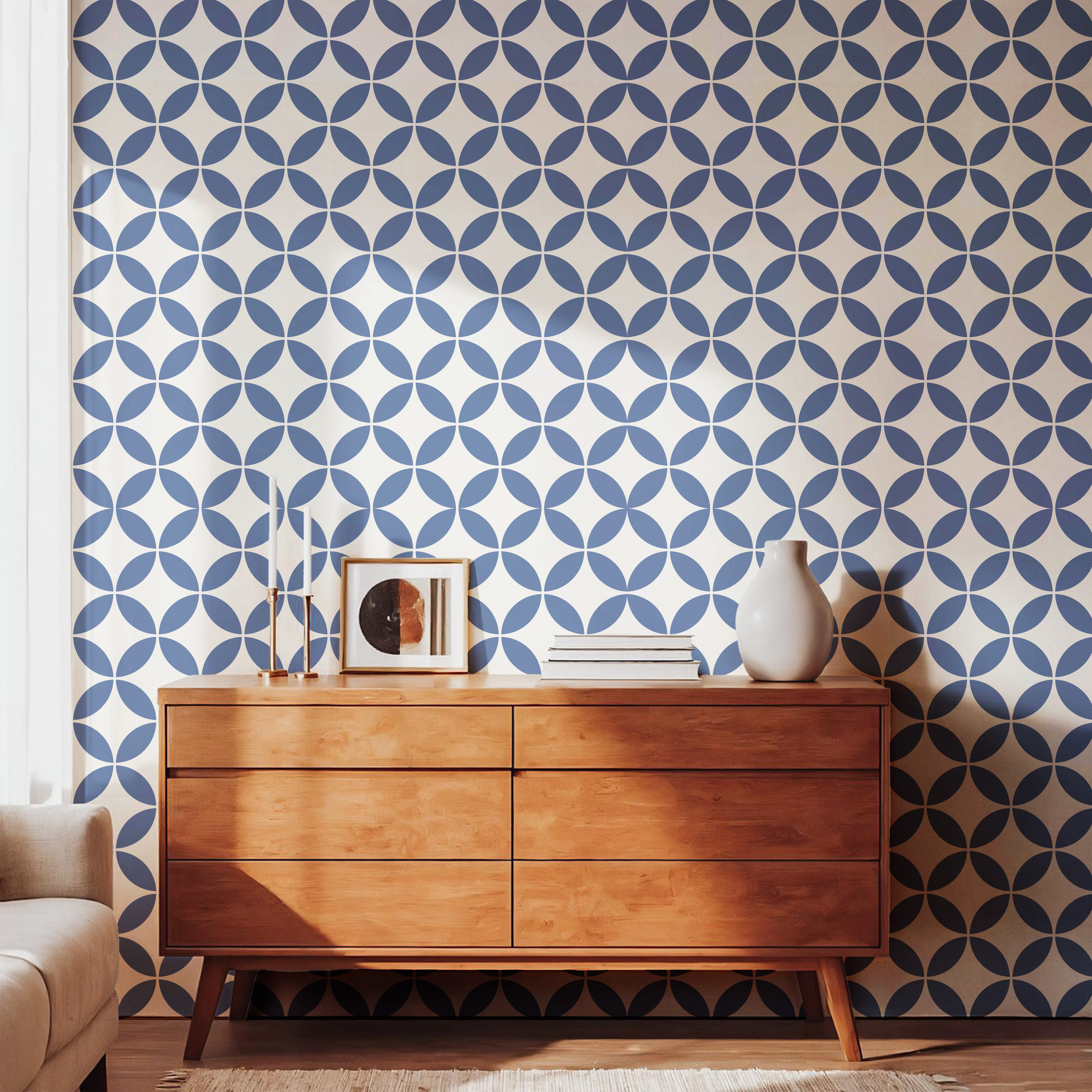 Navy blue geometric pattern wallpaper styled with a warm wooden dresser