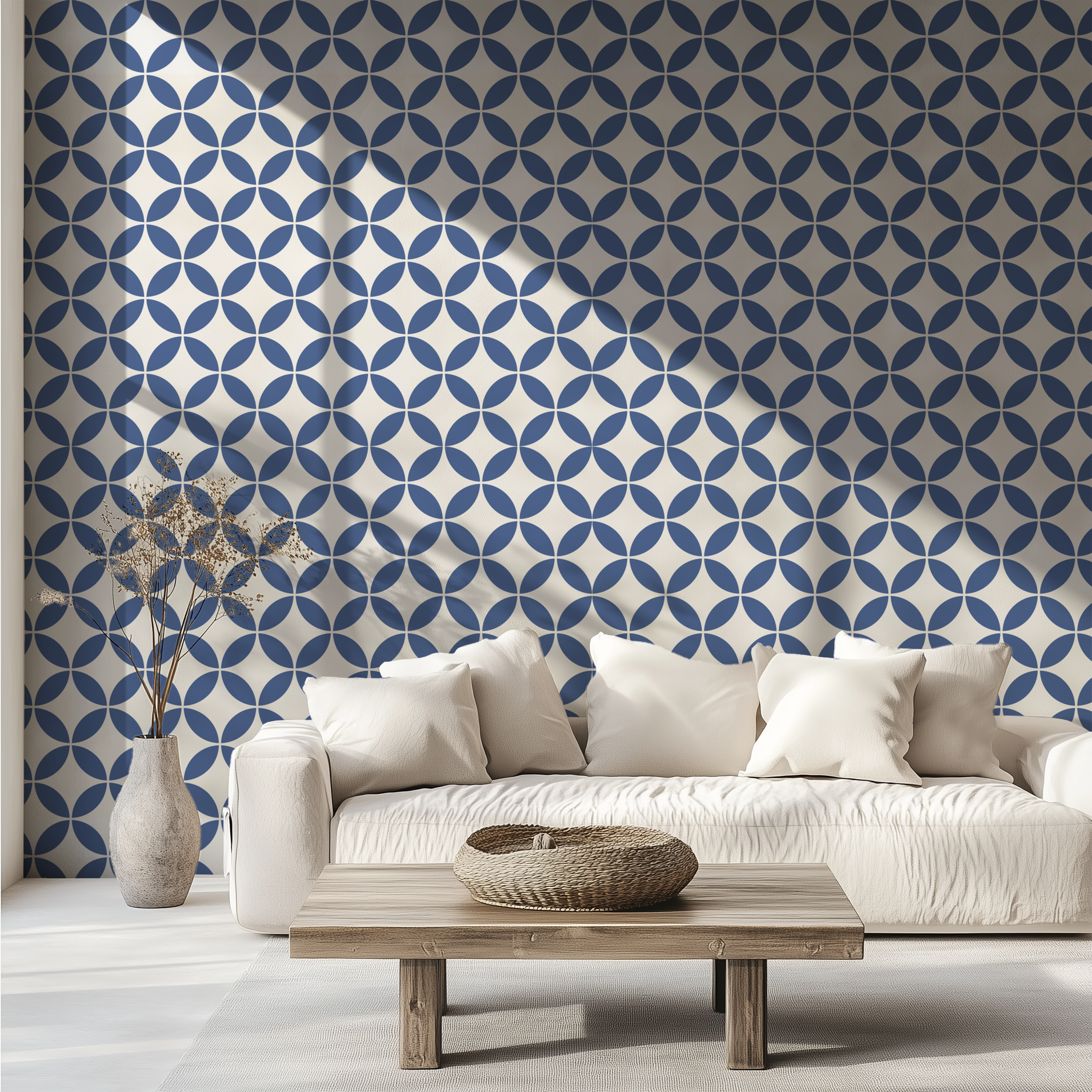 Navy blue mid-century geometric wallpaper with interlocking circles behind a white sofa