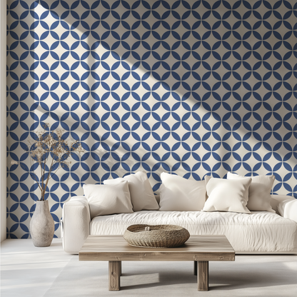 Navy blue mid-century geometric wallpaper with interlocking circles behind a white sofa
