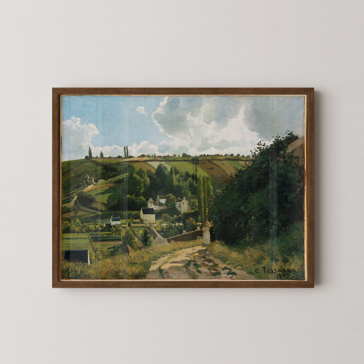 Dark wood-framed Jalais Hill landscape by Pissarro, with patchwork fields and billowing white clouds