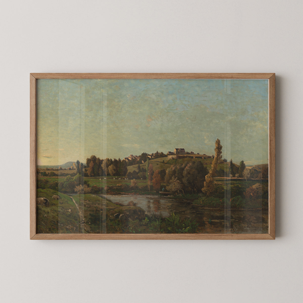 Natural wood-framed Harpignies landscape print with village houses, russet foliage and reflective water