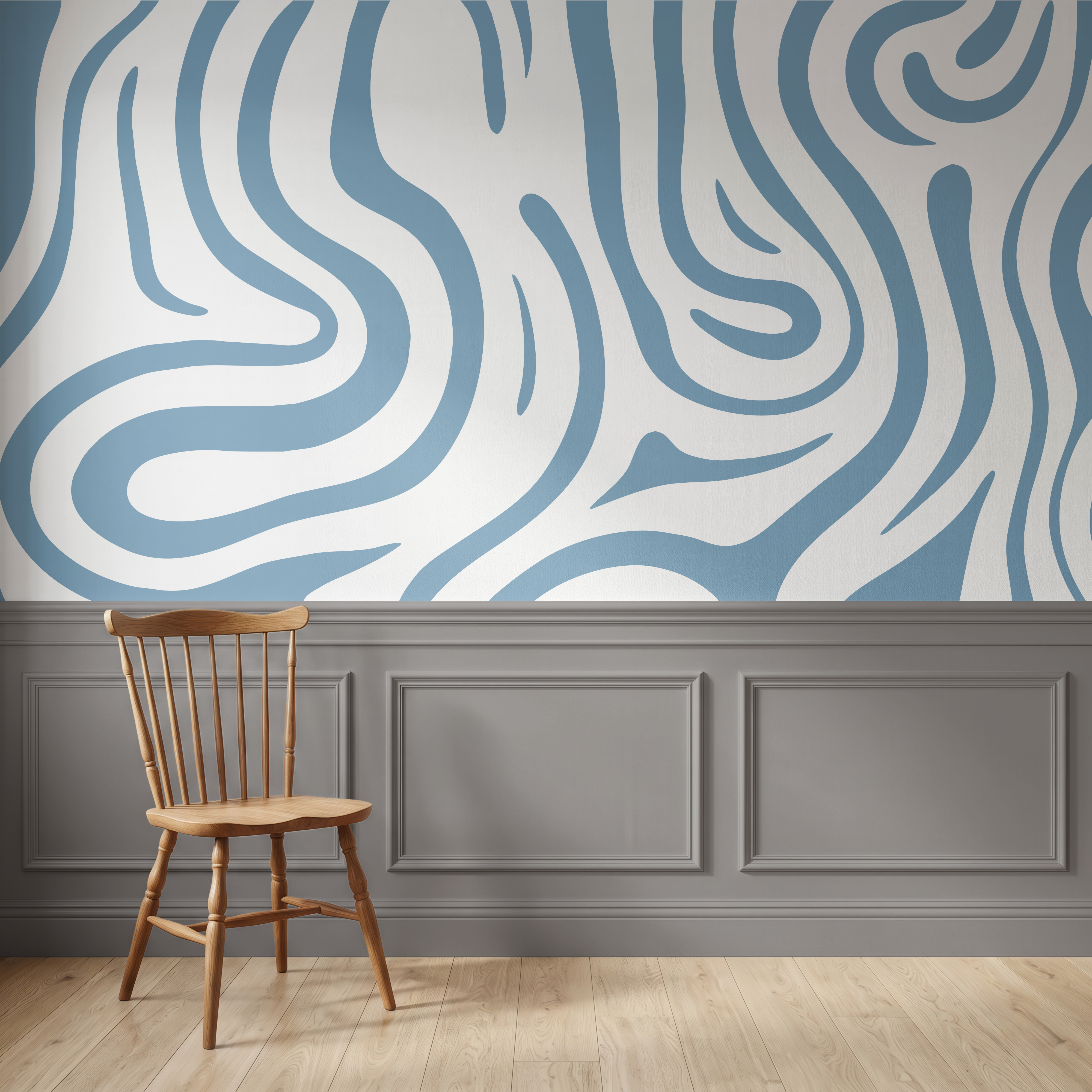 A styled interior scene showing a blue and white wavy abstract wallpaper on the upper wall, gray wainscoting along the lower wall, light wood flooring, and a wooden spindle-back chair in the foreground.