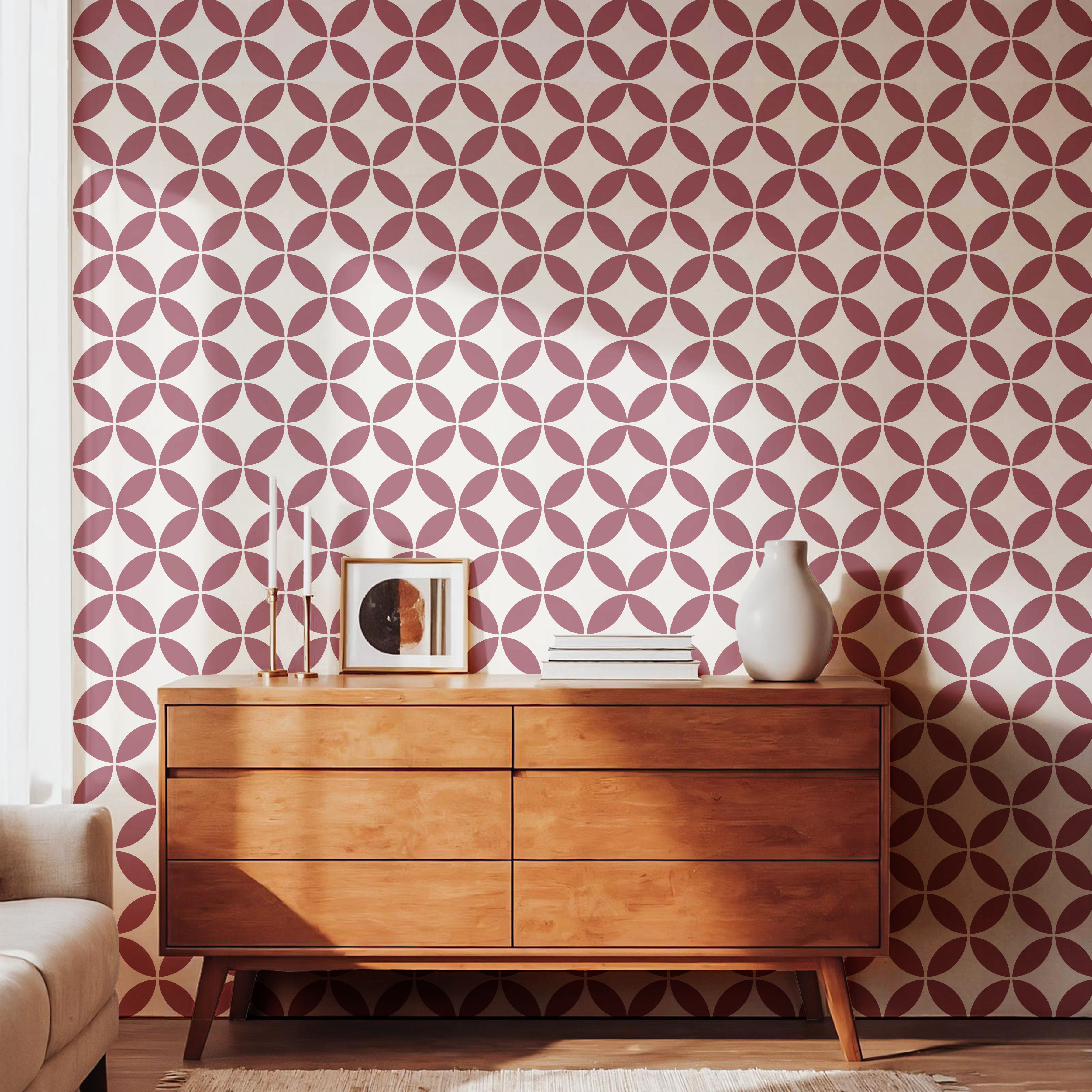 Burgundy geometric pattern wallpaper styled with a warm wooden dresser