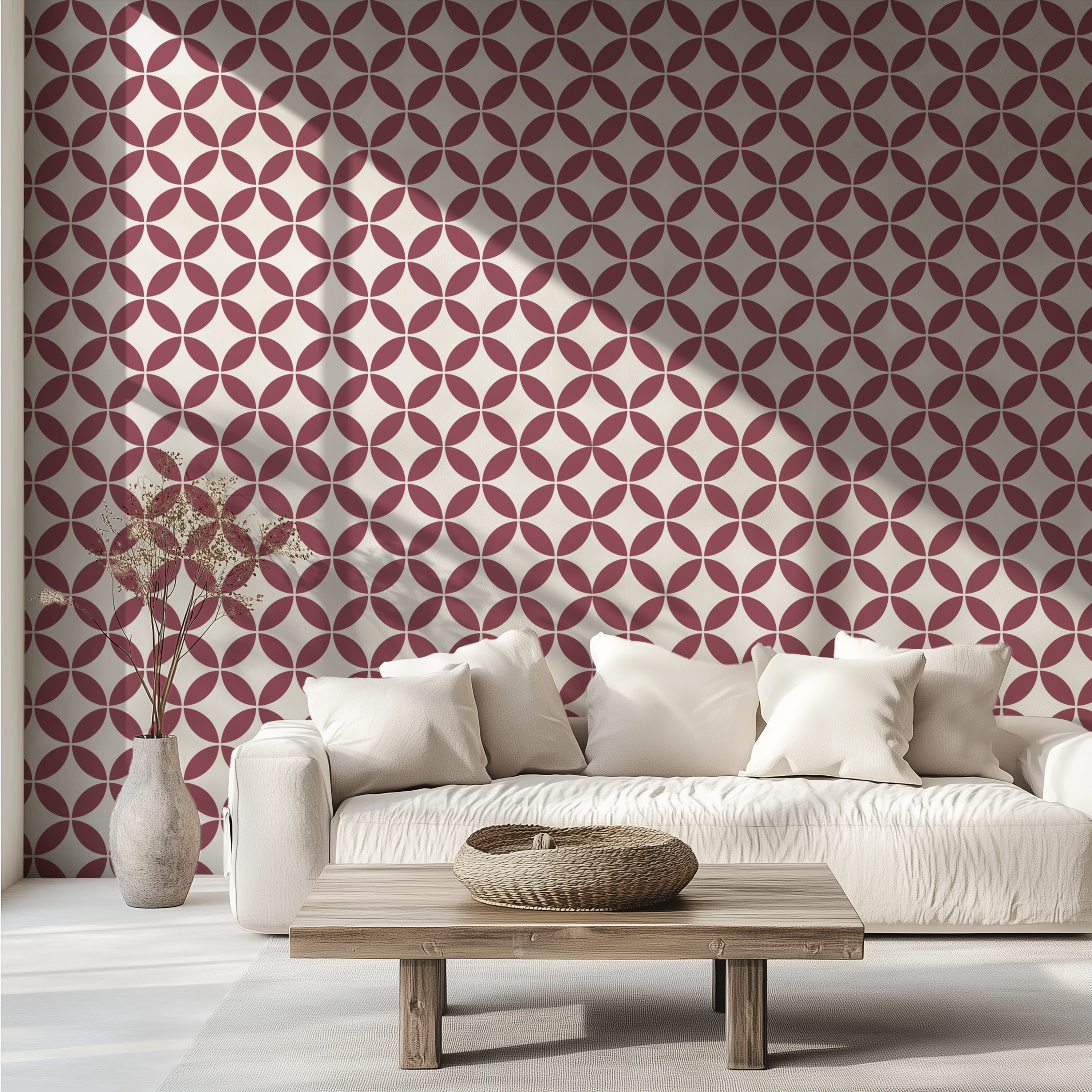 Burgundy retro geometric wallpaper with interlocking circles behind a white sofa