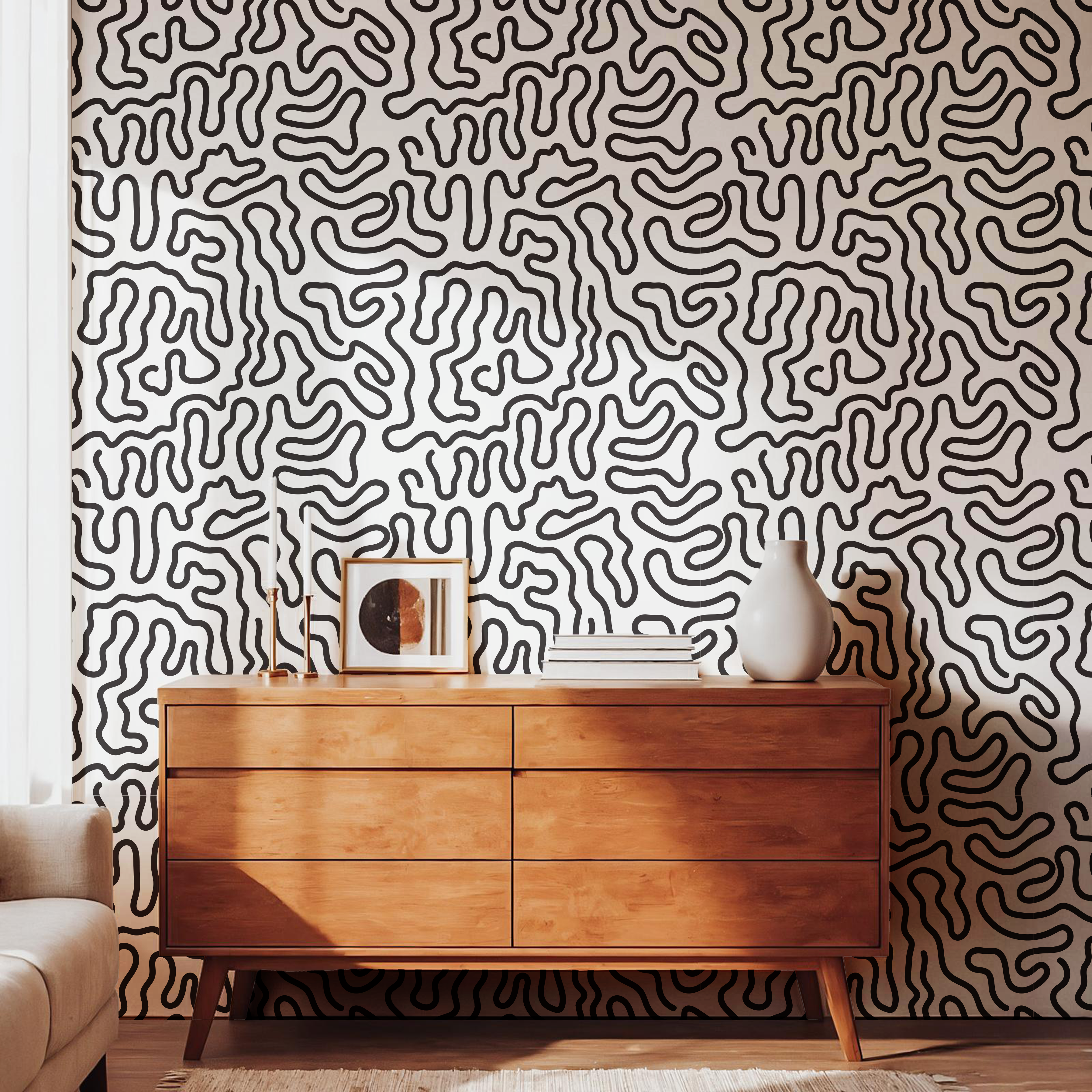 Black and cream abstract wallpaper with organic squiggle lines in a modern living room