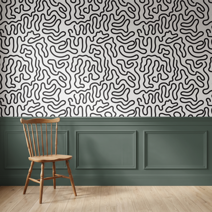 Black and cream line art wallpaper with a wavy organic pattern above wall panelling