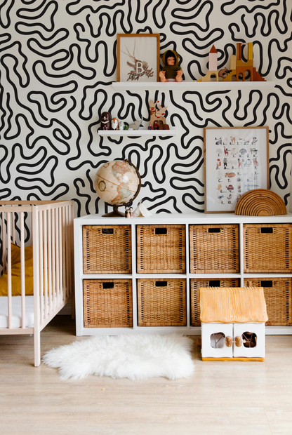 Black and cream abstract squiggle wallpaper styled in a modern nursery and kids roo