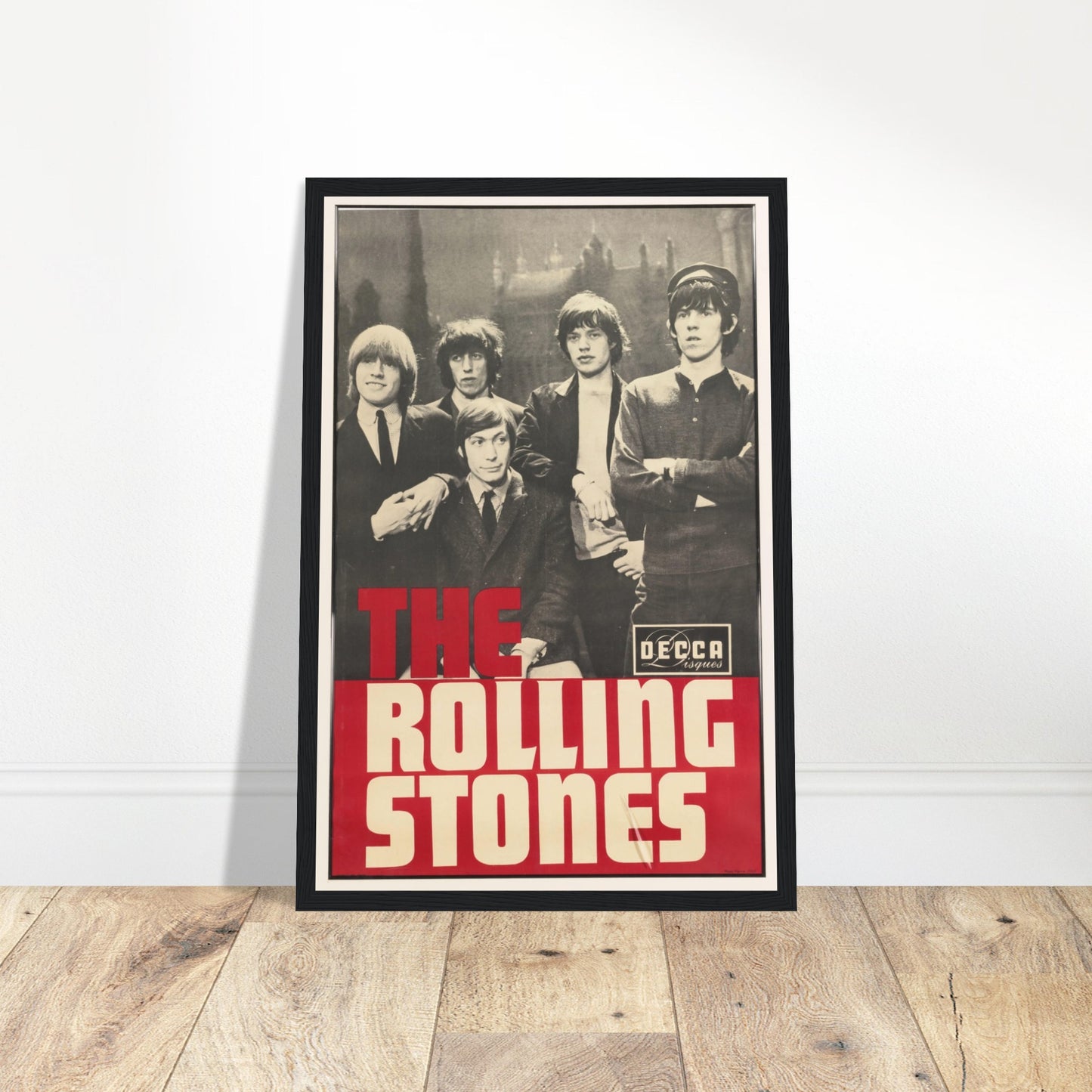 Vintage black and white Rolling Stones poster featuring 1960s band lineup and bold red typography from Decca Records.