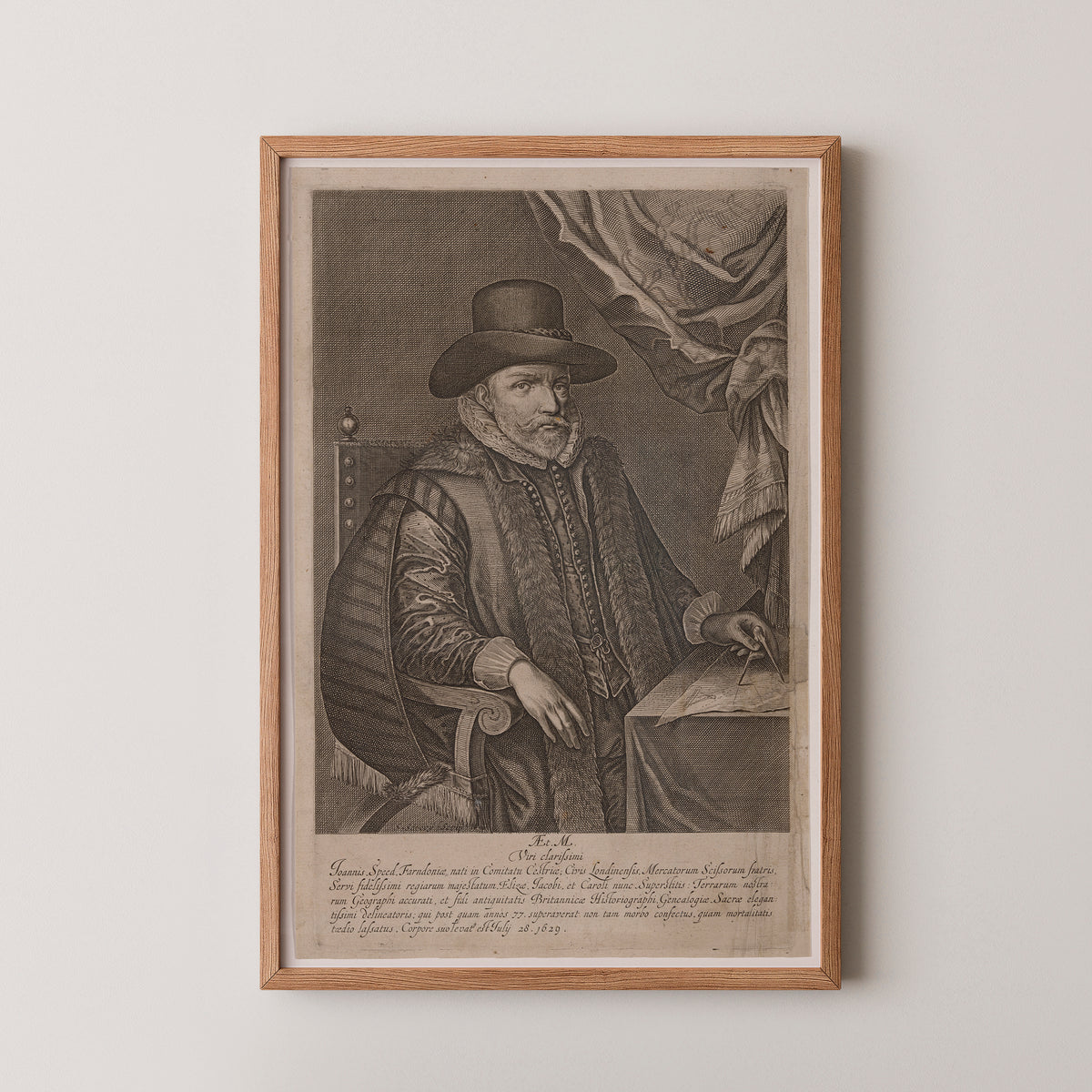 John Speed seated at a desk with a drafting instrument, period dress and inscription, natural wood frame