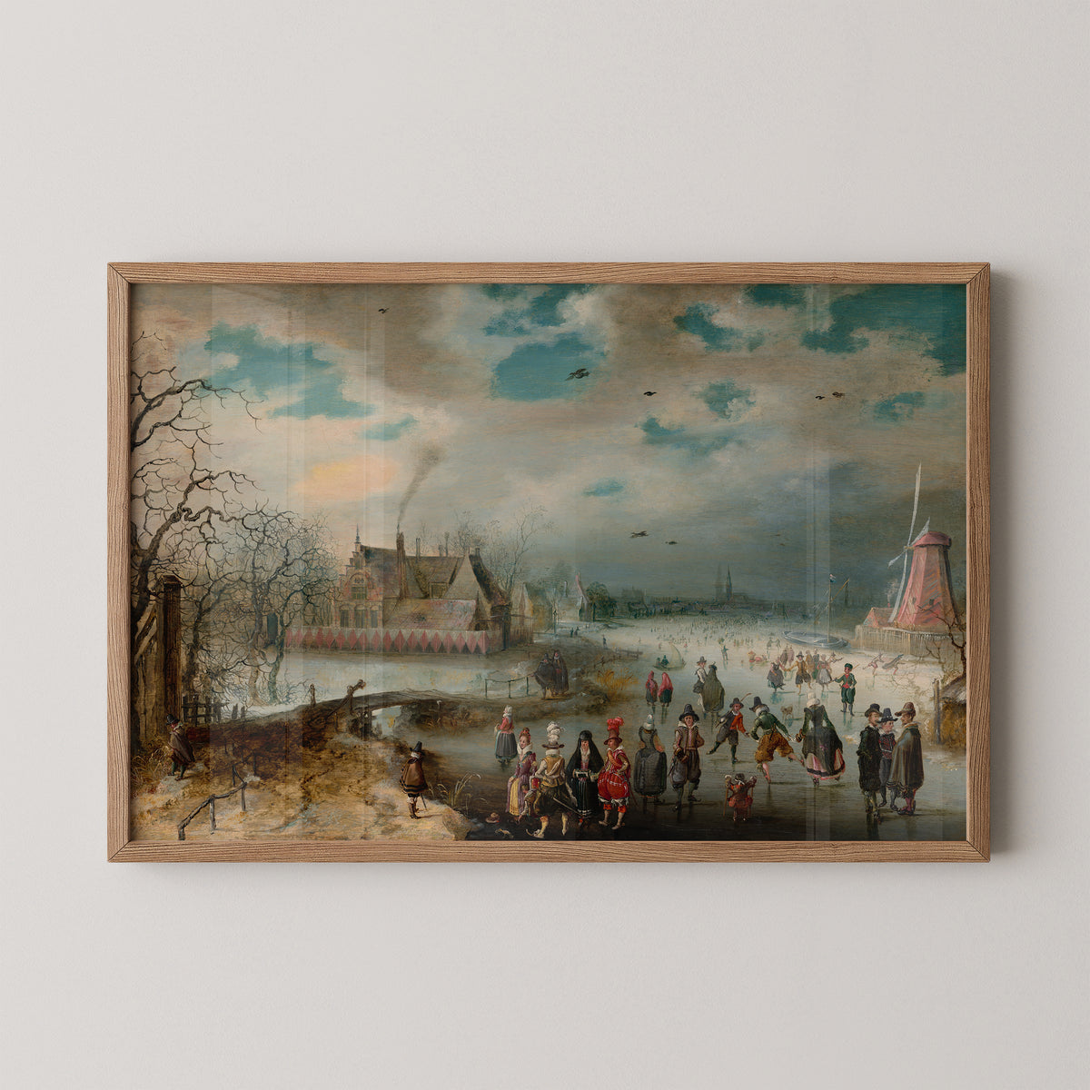 Natural wood-framed van Breen print with ice skaters and red and pink clothing across a frozen river