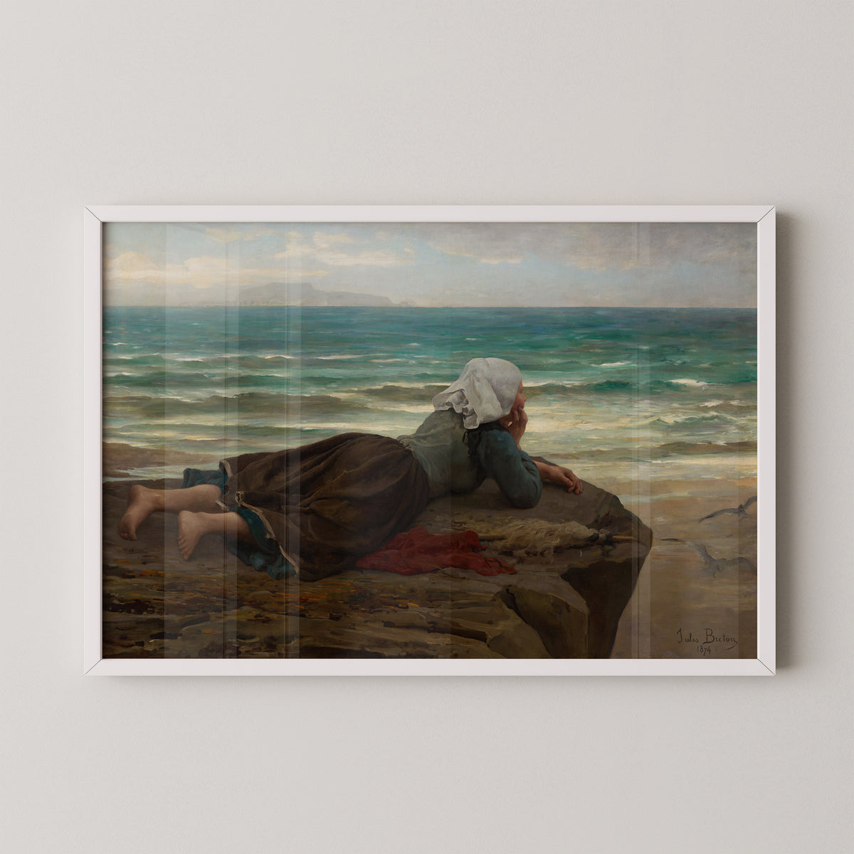 White-framed Breton coastal art print, showing small waves and distant land beyond a solitary woman