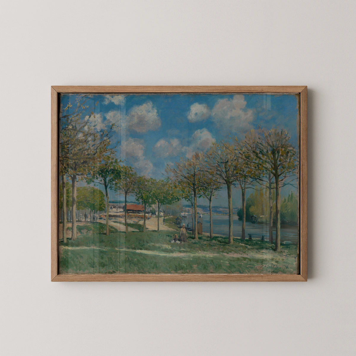 Natural wood-framed Sisley print with branching trees, green riverbanks and blue water at Bougival