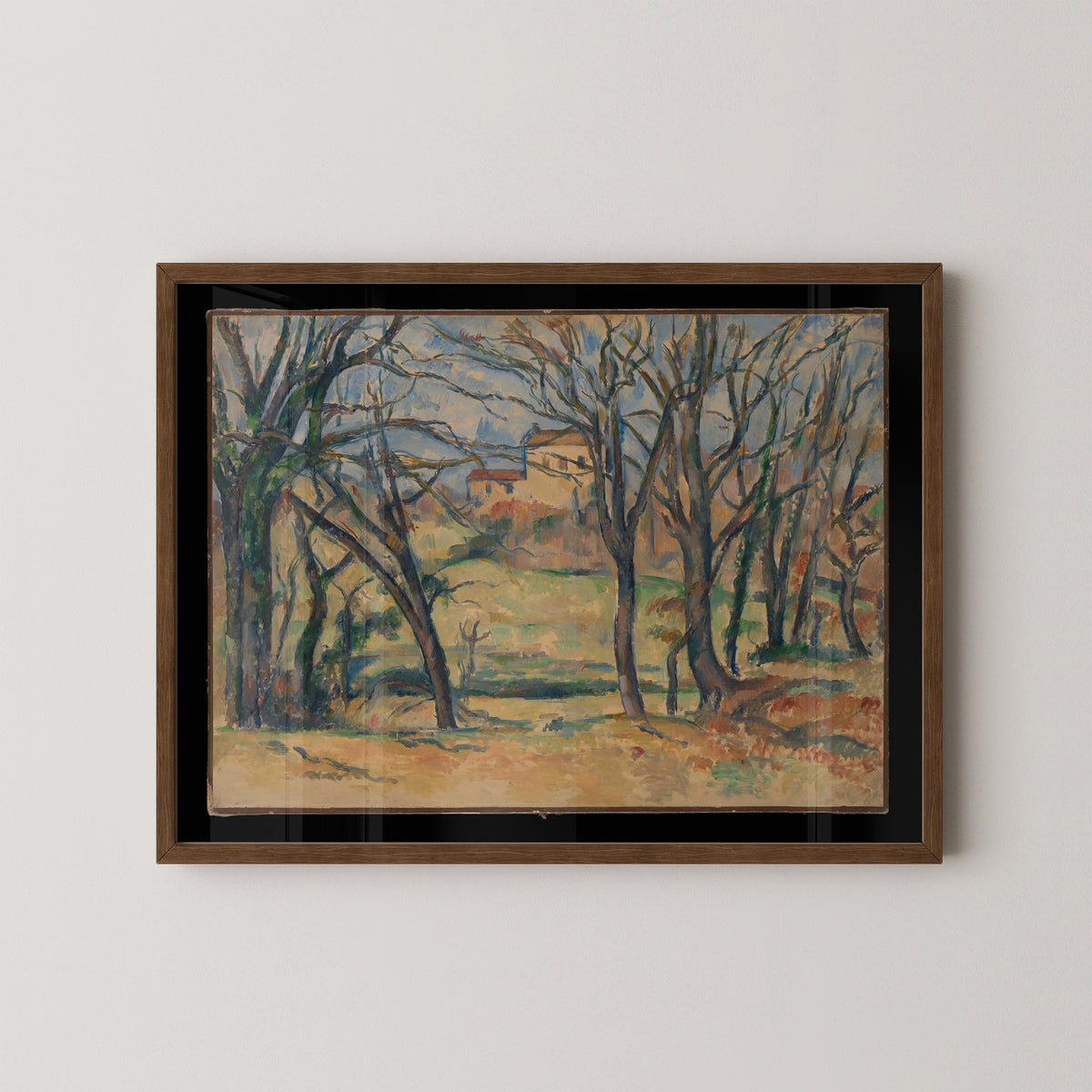 Post-Impressionist landscape by Cézanne in a dark wood frame, with blue-gray trunks and warm earth tones