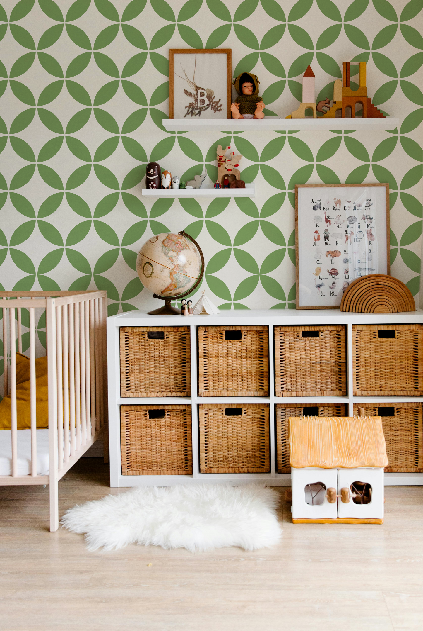 Green geometric wallpaper with a playful retro pattern in a modern nursery and kids room