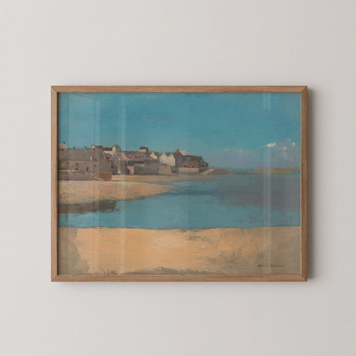 Natural wood-framed Redon coastal print with cream houses, brown roofs and sandy open ground