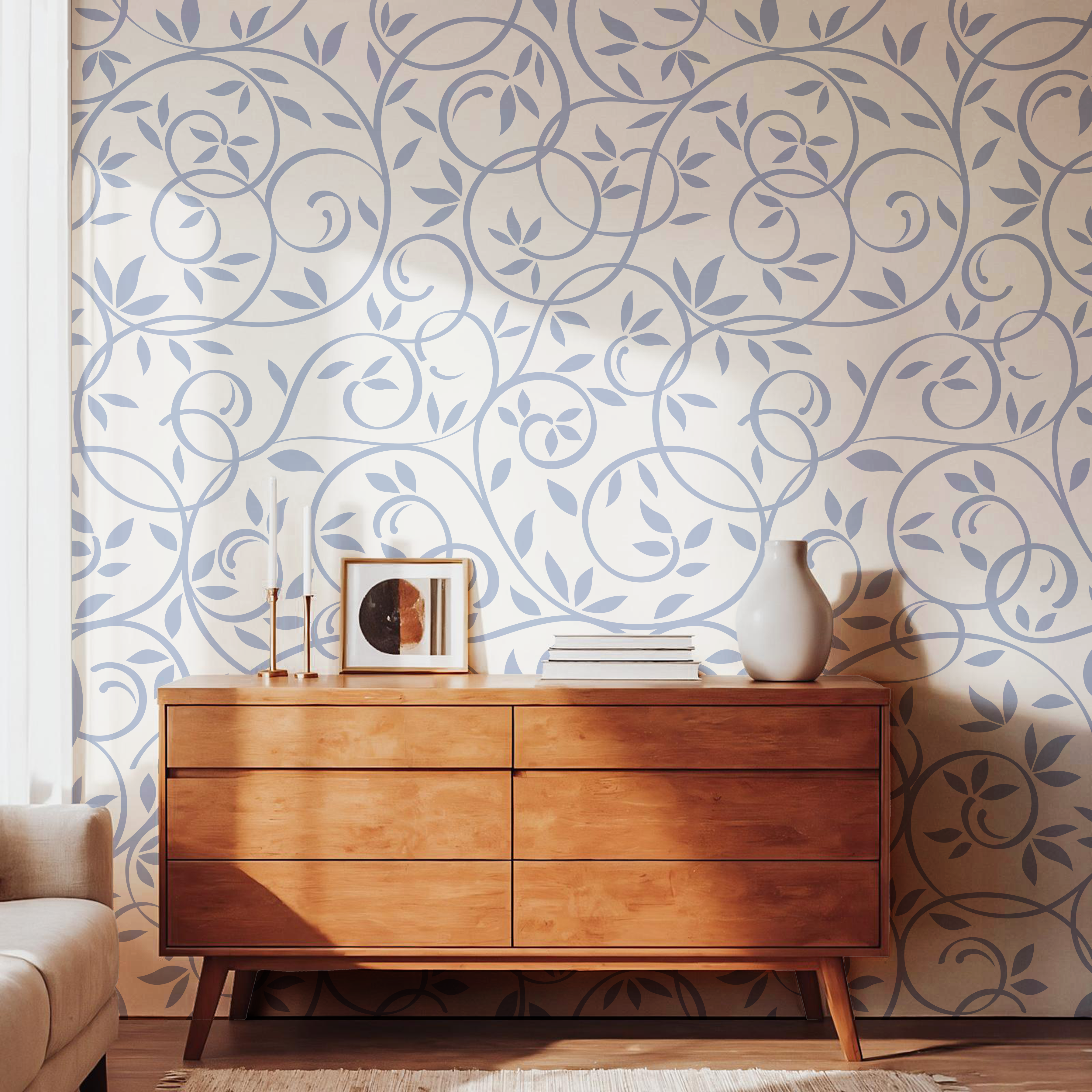 Dusty blue floral vine wallpaper styled with a natural wooden dresser