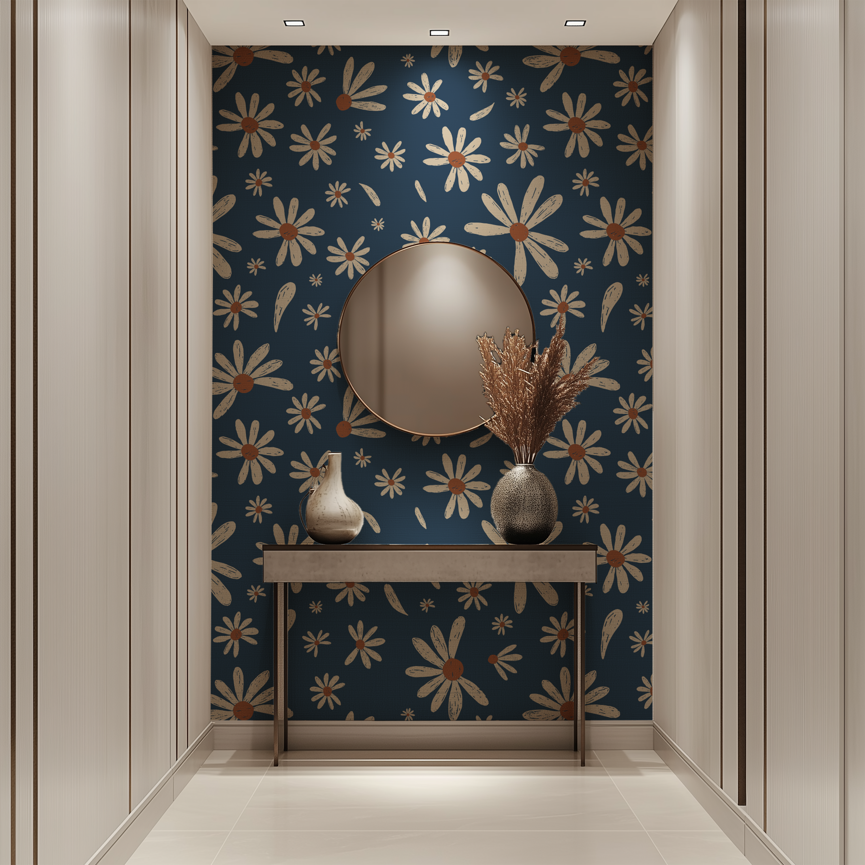 A styled interior hallway or entryway with cream paneled walls, a dark blue wallpaper featuring a repeating cream daisy and leaf pattern, a round wall mirror, a console table, and two vases with dried grasses.