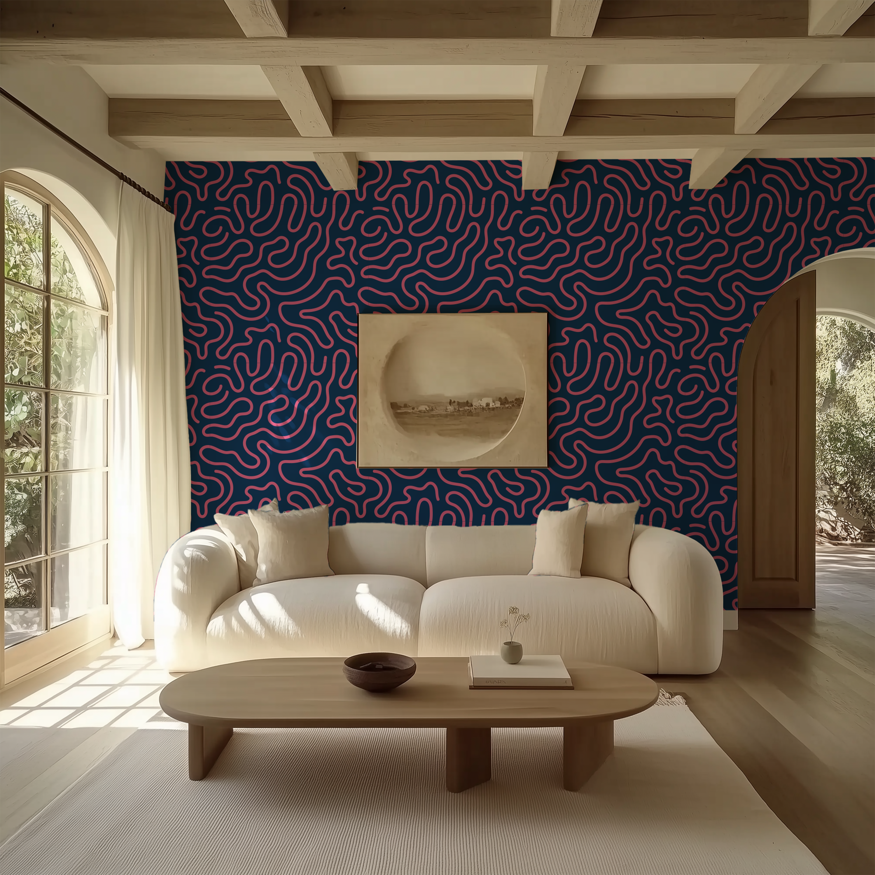 A modern living room featuring a cream curved sofa against a bold blue and red wavy patterned wallpaper, with a light wood coffee table and cream rug in the foreground.