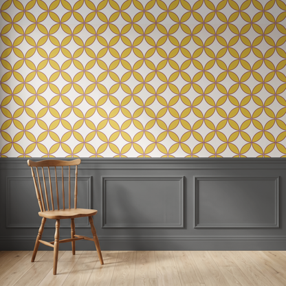 Yellow and white geometric patterned wallpaper with a dark gray wainscoted wall and a wooden spindle-back chair in the foreground.